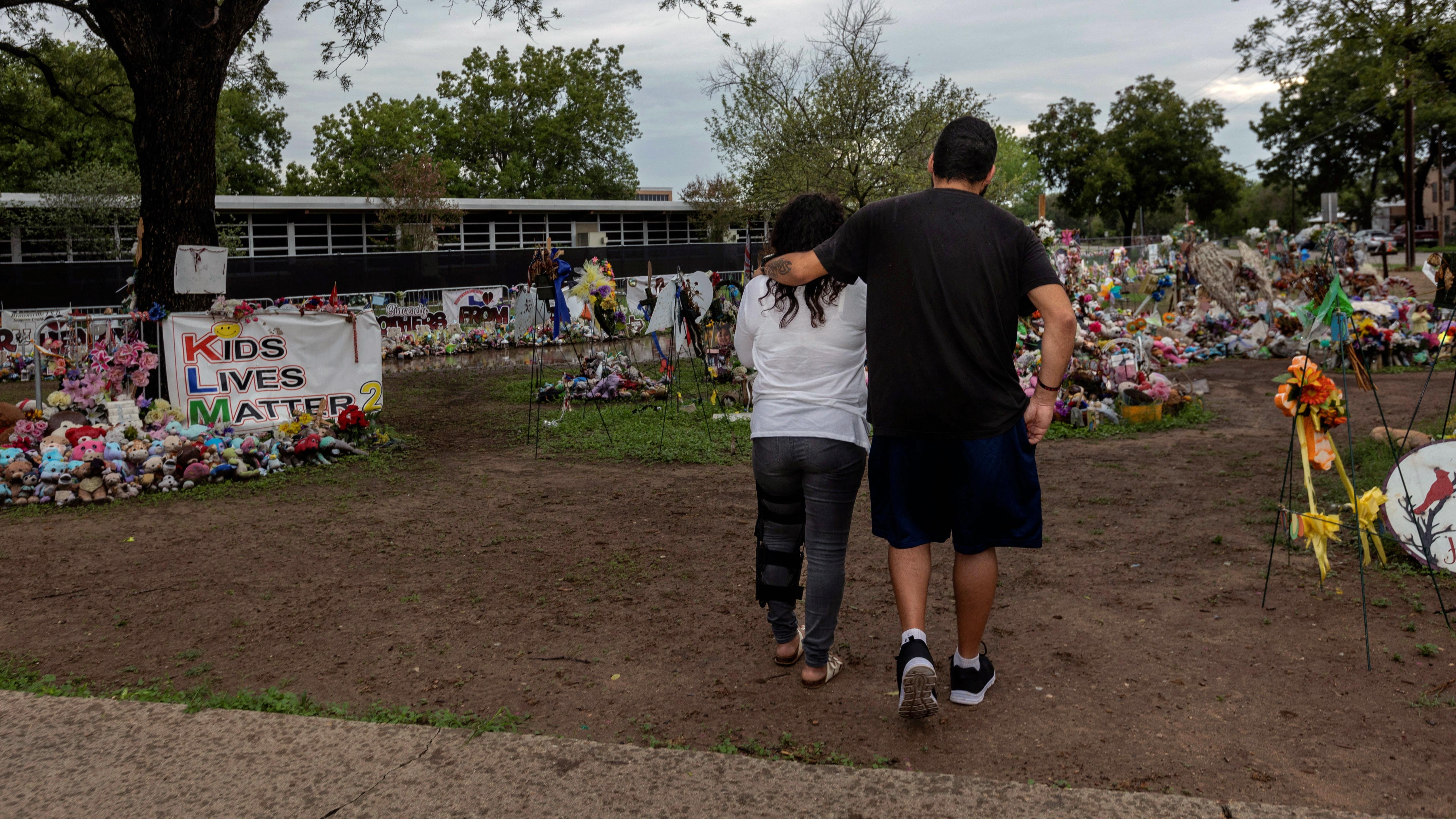 A couple outside of Robb Elementary School before the start of the new school year following the mass shooting in Uvalde, Texas. August 31, 2022.