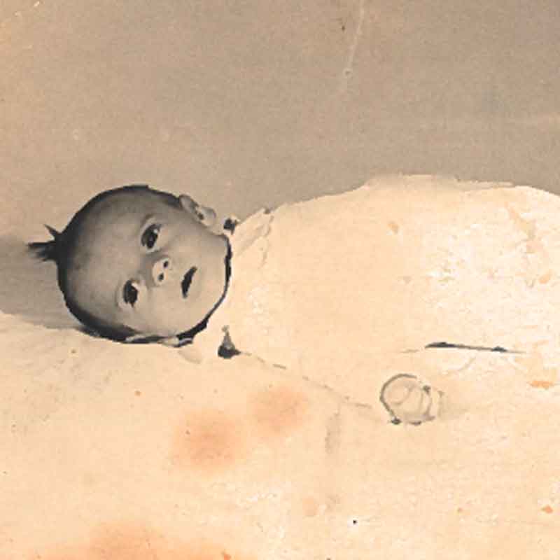 Theresa at 2 months old. Her mother sent this postcard photograph to Theresa’s father, but it was returned undelivered with the words, 'Not allowed. Against the law.'