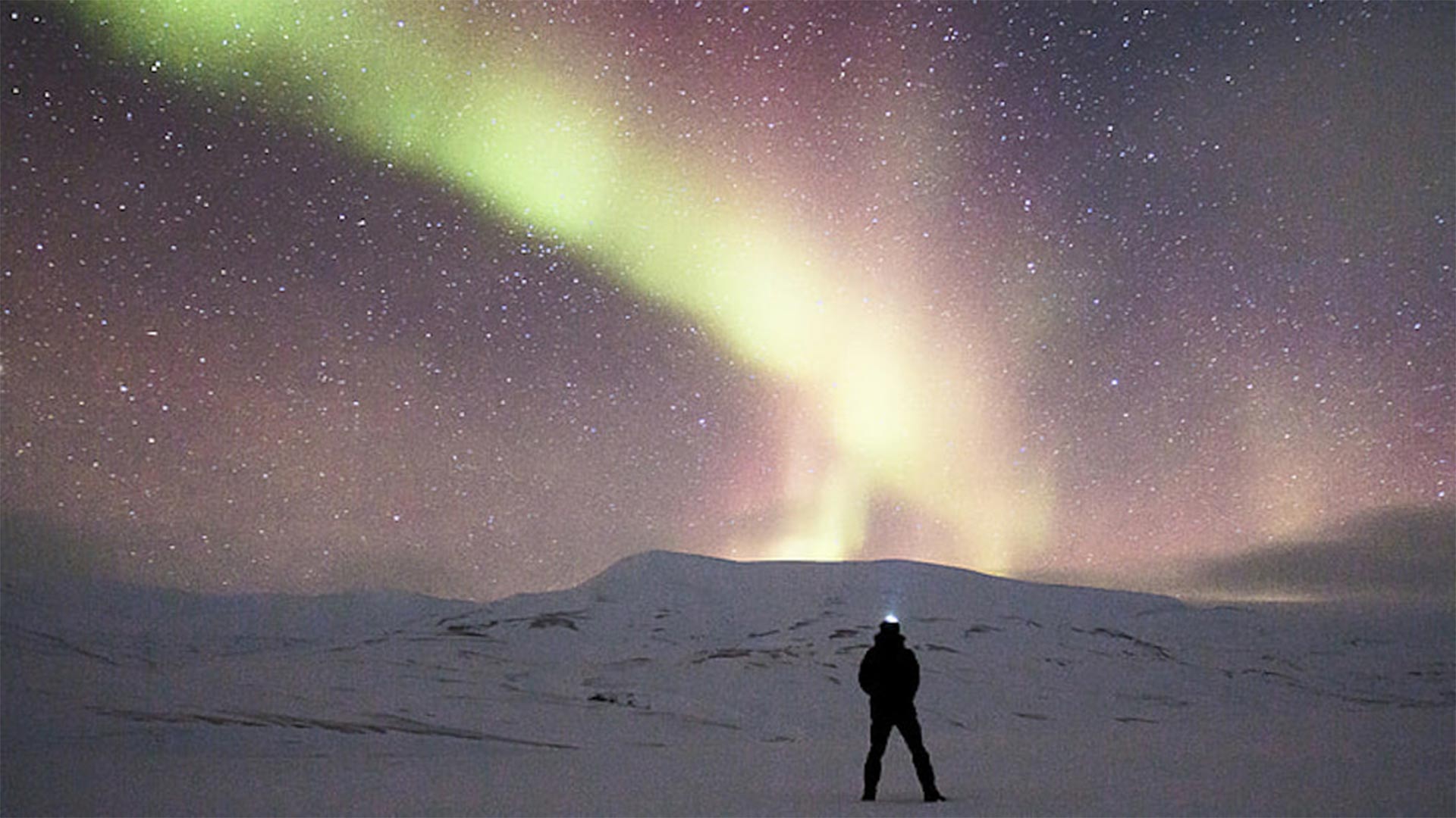 Man alone with Northern Lights