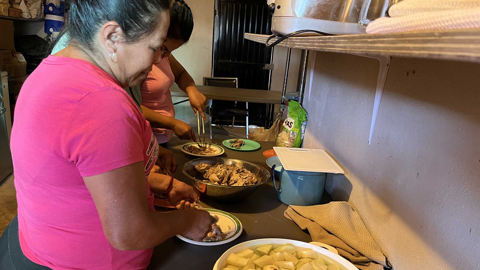 Women prepare food for dozens of families at Centro de Esperanza migrant shelter in Sonoyta, Sonora.