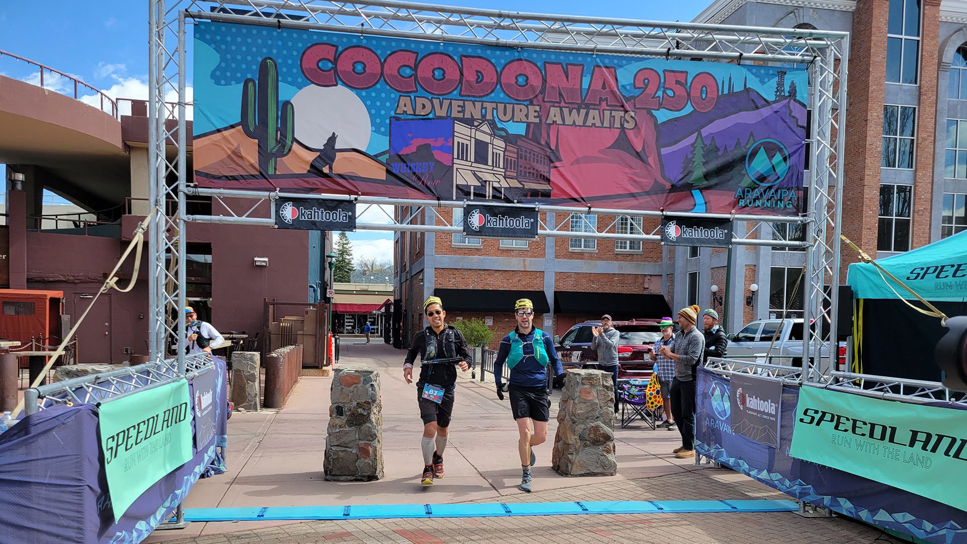 Leo Fung (left) and his pacer cross the finish line of the Cocodona 250 in downtown Flagstaff. He finished the 250-mile race in 100 hours, 30 minutes, 24 seconds.