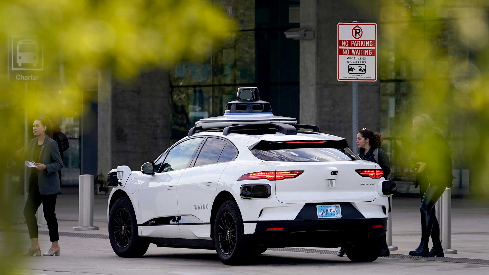 A Waymo self-driving vehicle sits curbside on Dec. 16, 2022, at the Sky Harbor International Airport Sky Train facility in Phoenix. Self-driving car pioneer Waymo announced Thursday, May 4, 2023, that its robotaxis will be able to carry passengers through most of the Phoenix area for the first time. 