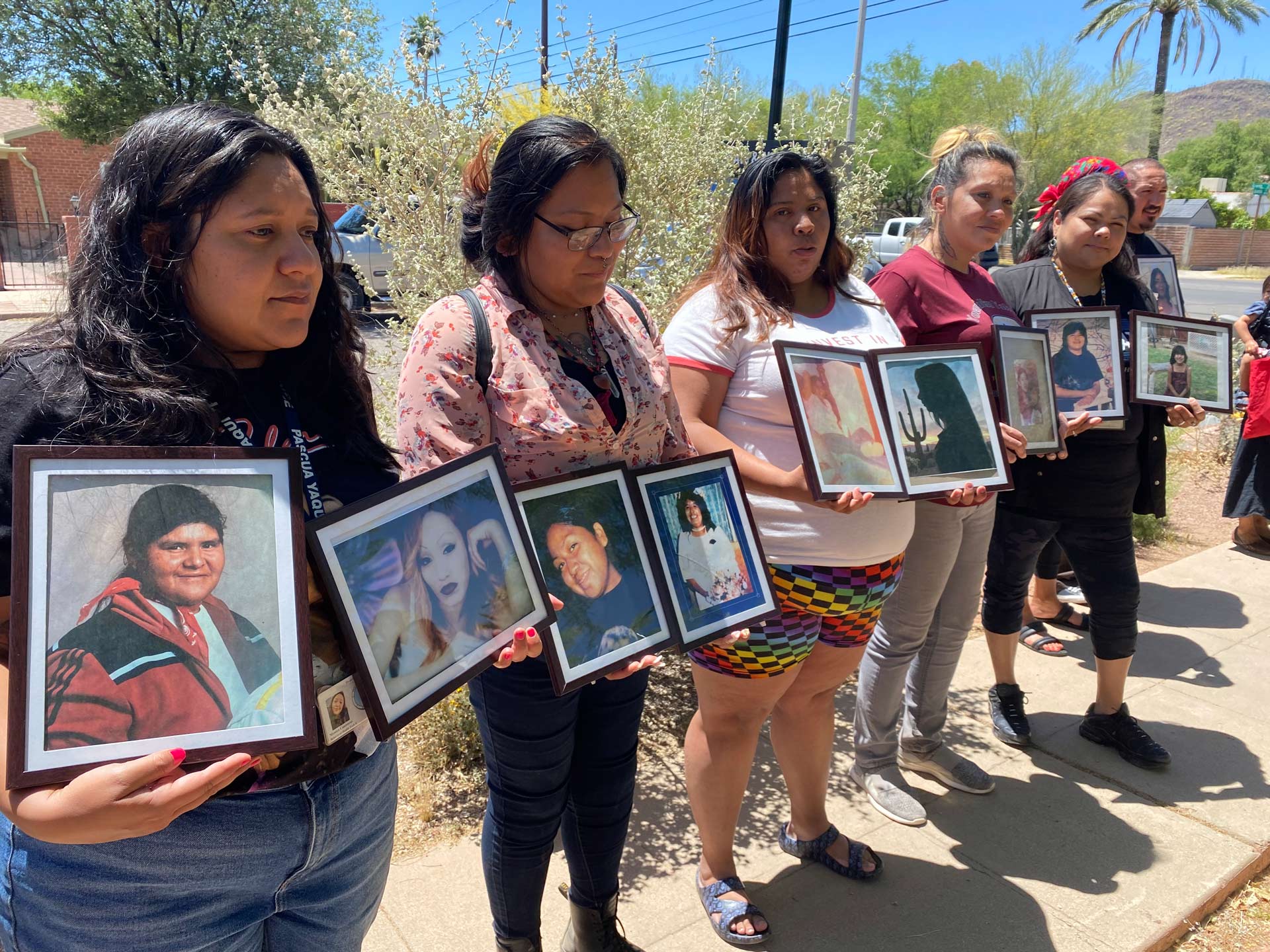 Women hold photos of loved ones during a press conference on missing and murdered indigenous women on Friday, May 5 at the city council Ward 1 office.
