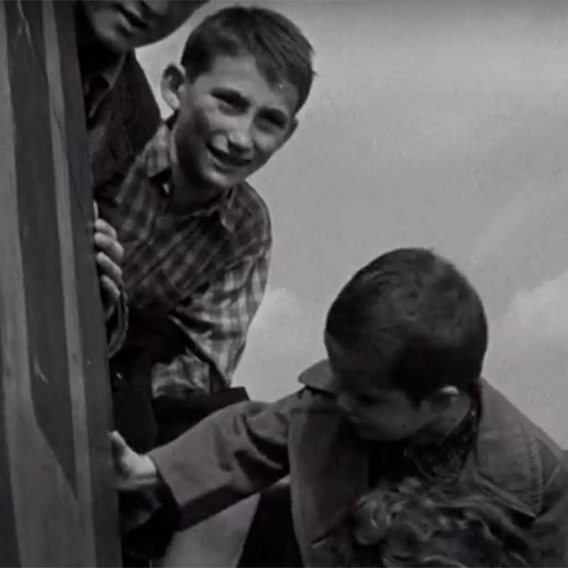 Sidney (center) in 1945. He was 13 years old when he was taken to England. 