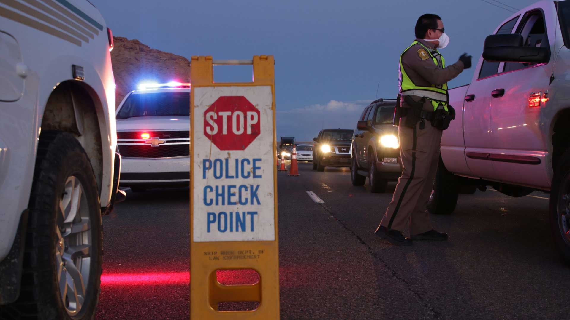 Navajo police officers from the Shiprock District conduct a checkpoint on April 1, 2020, to remind the public about the nightly curfew on the Navajo Nation. 