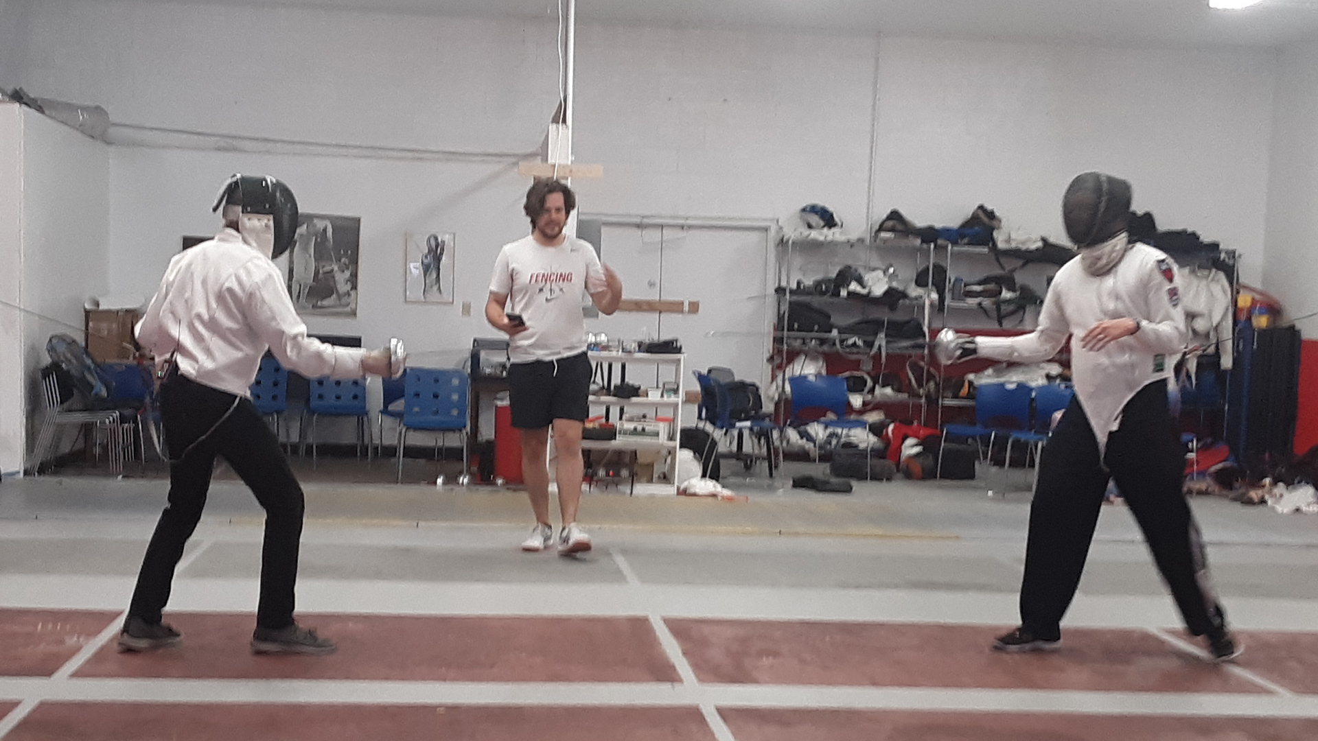 More Than a Game host Tony Perkins (left) prepares to take on Still Point Fencing instructor Jay Fowler (right) while fellow instructor Nick Going officiates.