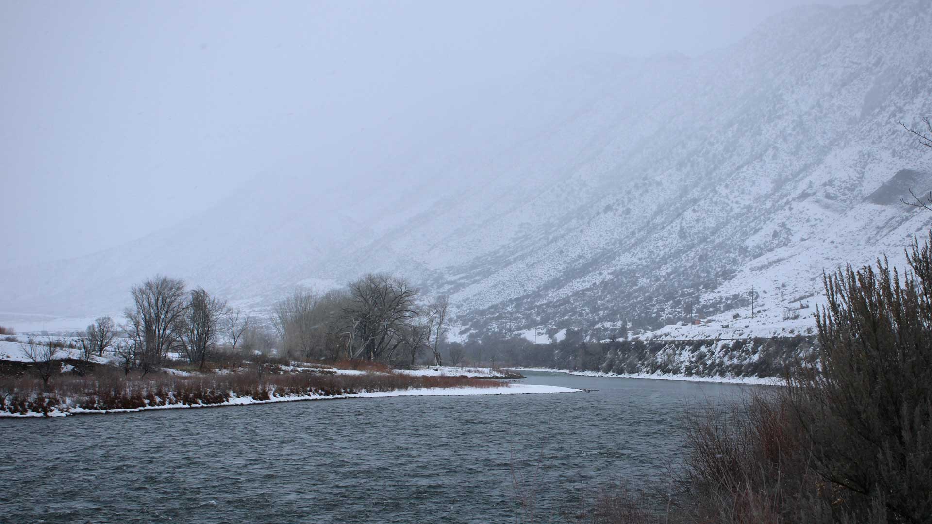 Snow falls on the Colorado River near New Castle, Colorado, on January 11, 2023. Months of snow and rain soaked a region in the grips of drought and helped replenish reservoirs along the Colorado River.
