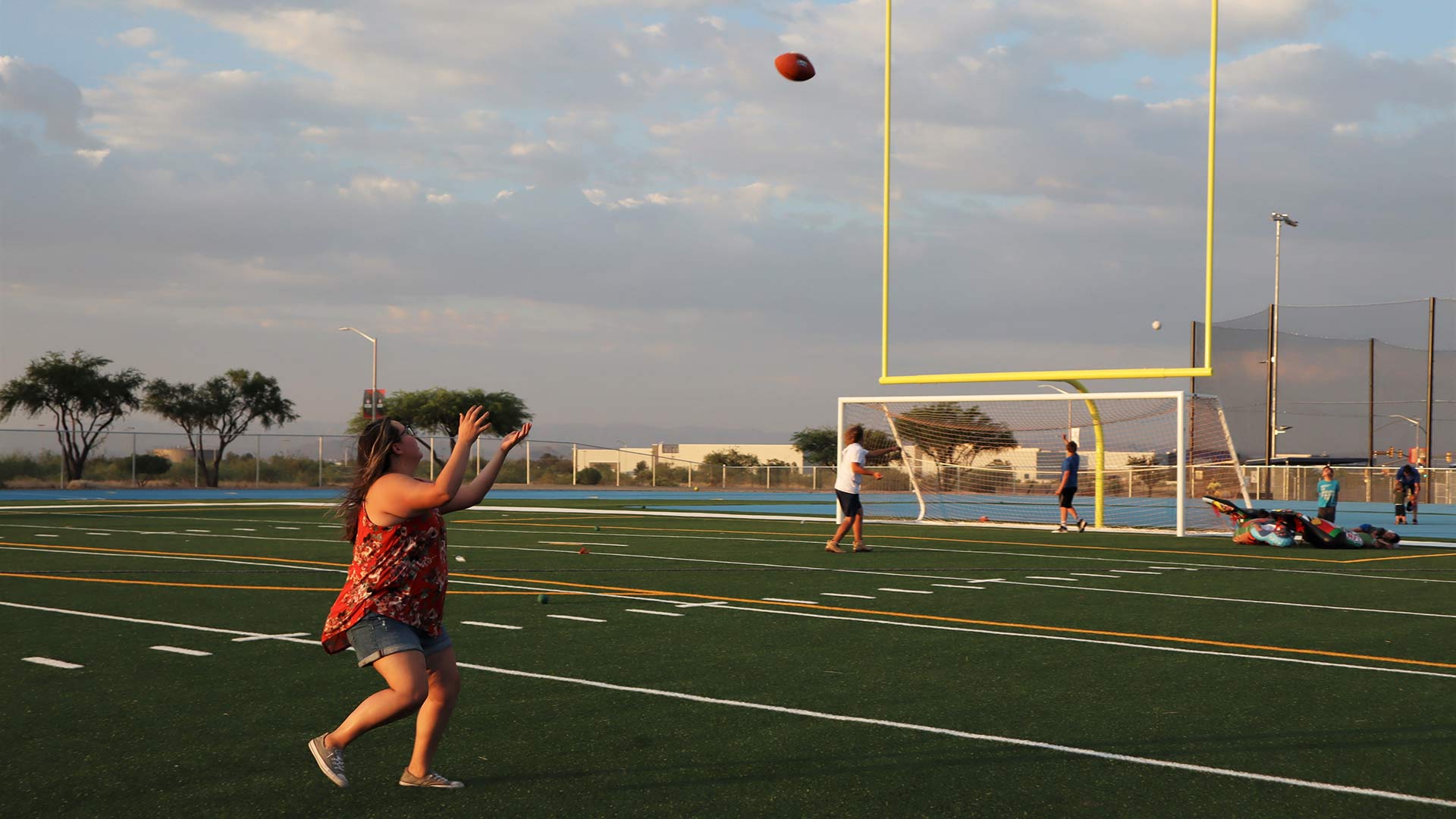 Caitlin Lopez tests out the new football field during the grand opening of the Veterans Memorial Park Sports Complex. June 28, 2023.