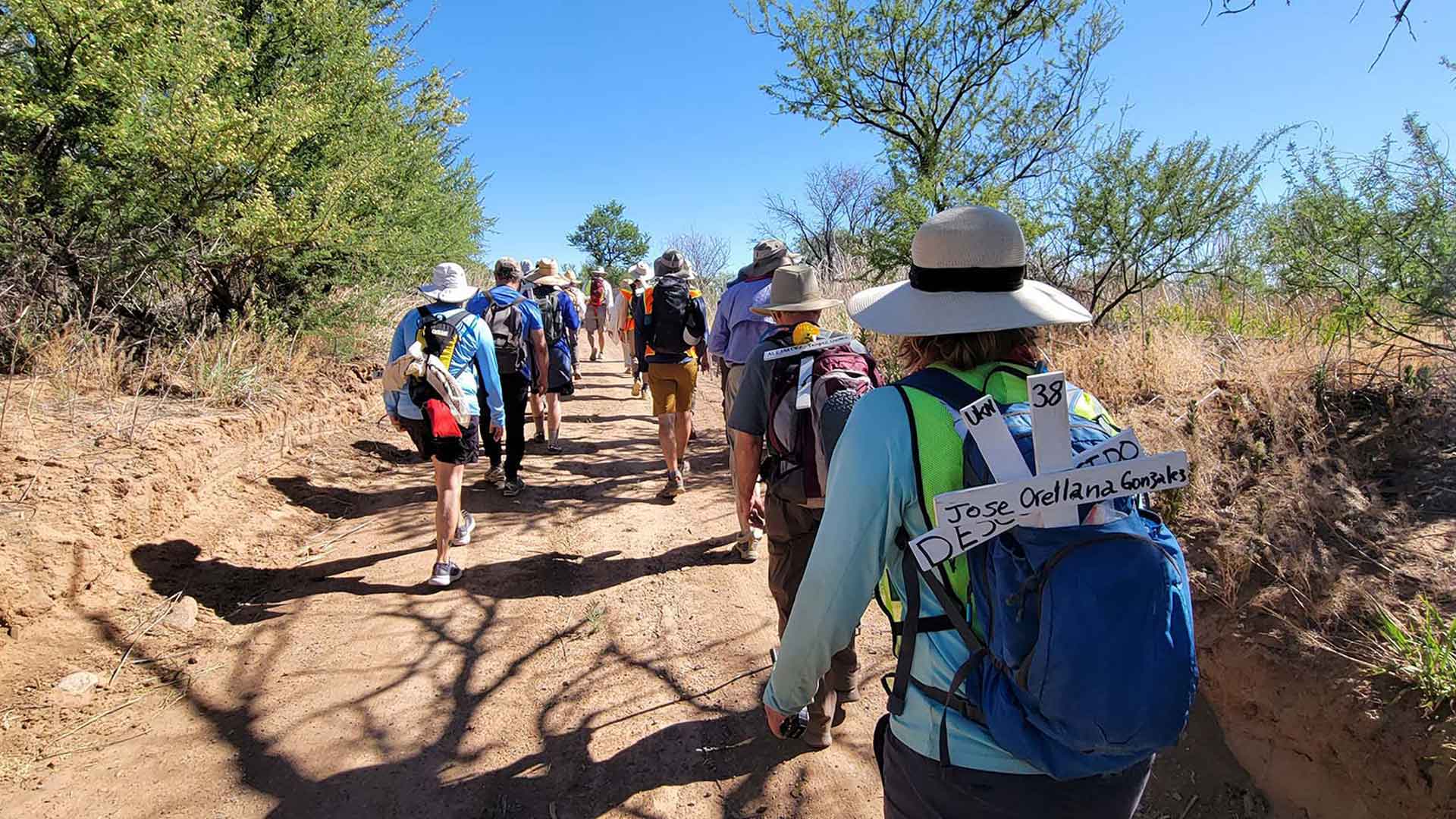 Participants on the 20th annual Migrant Trail Walk carry crosses with the names of those who have died in the U.S.-Mexico borderlands. 