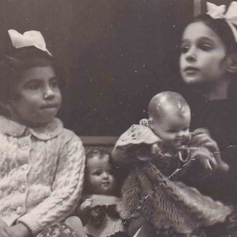 Mushka (right), age 7, on a New York City subway train with a friend. She and her parents managed to escape from Nazi-occupied France and move to the United States in 1941.