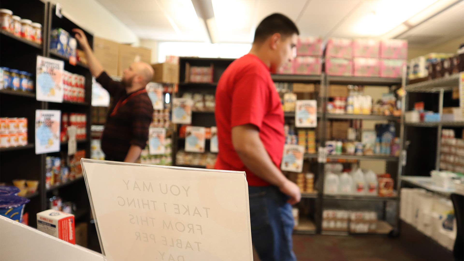Cochise College Student Wellness Manager Loren Gladwill (left), and Cochise College Sophomore and work study Isidro Calvillo (21, right) inside the Cochise Cupboard Food Pantry, which is located in the 600 building at the college's Douglas Campus. July 3, 2023.