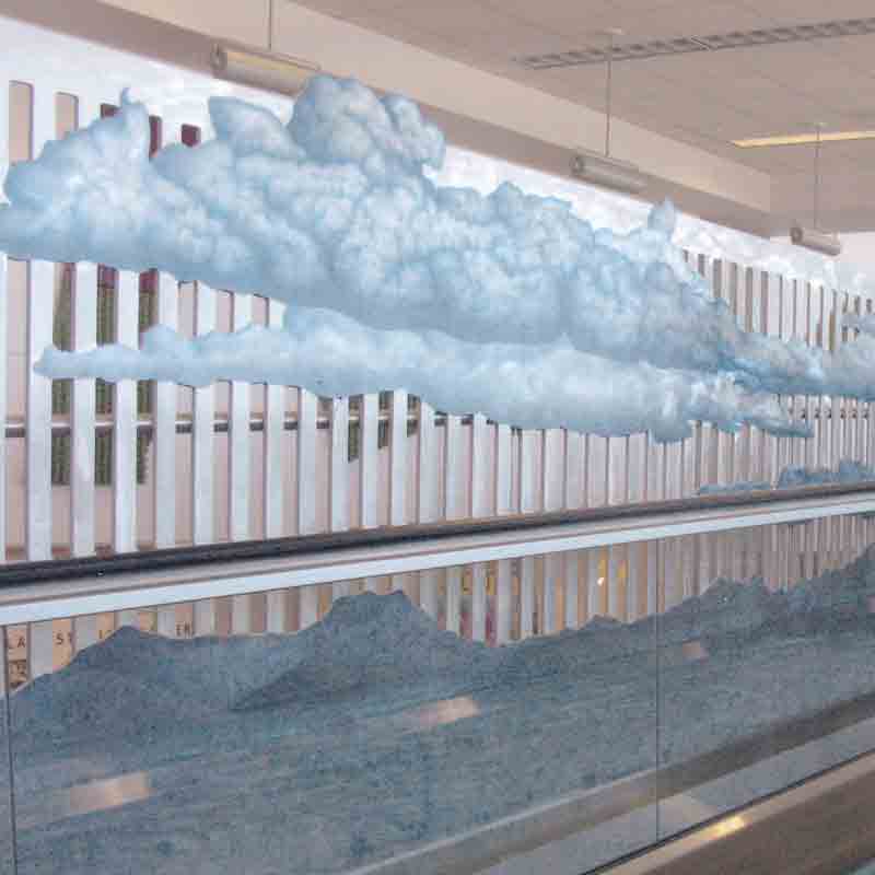 'Silver Linings' is a public art piece created by Chris for the Tucson International Airport. She says as travelers are carried along the moving walkway, they can feel as if they’re rising above the clouds.