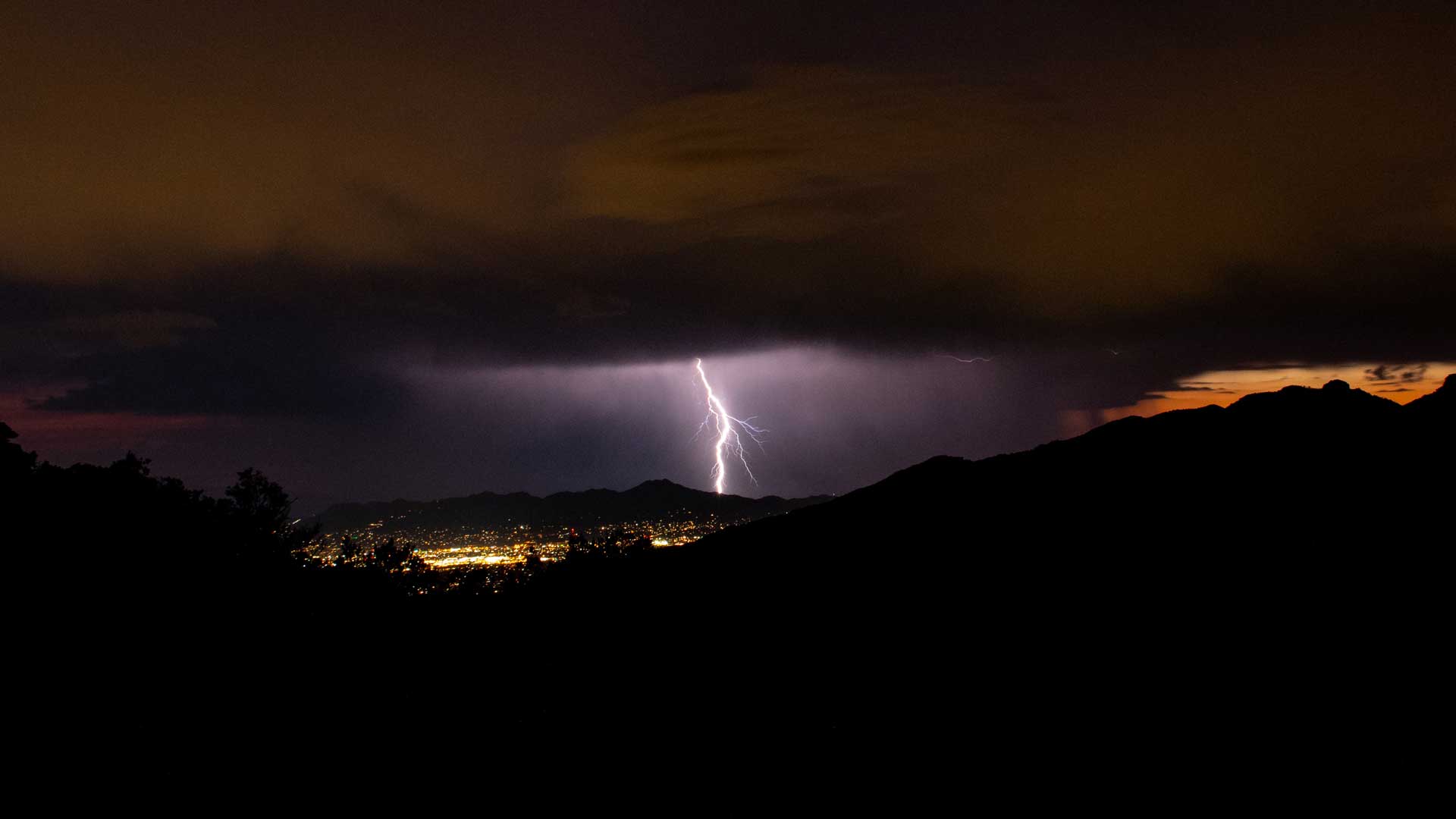 Lightning flashes over the Tucson mountains as seen from Windy Point in the Santa Catalina mountains.