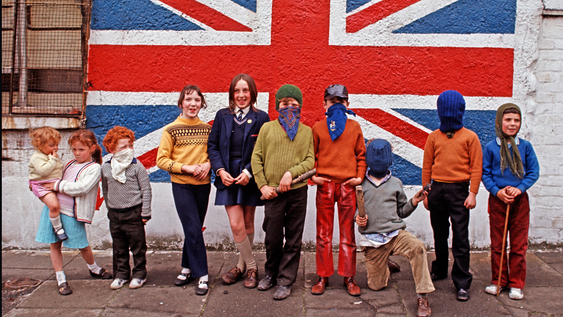 Children from a Loyalist area in Belfast in front of a Union Jack flag mural, Northern Ireland, 1971