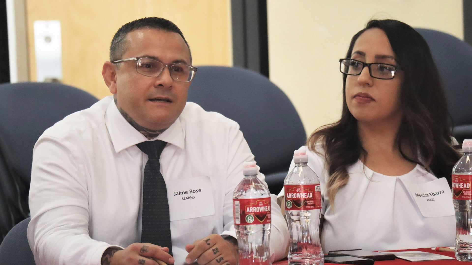 Jaime Rose, Southeast Arizona Behavioral Health Services Recovery Aid (left), and Monica Ybarra, co-chair of the Cochise Addiction Recovery Partnership, talking to Attorney General Kris Mayes during a round table discussion about the opioid settlement funds in Bisbee. July 26, 2023. *Photo by Summer Hom, AZPM News.*