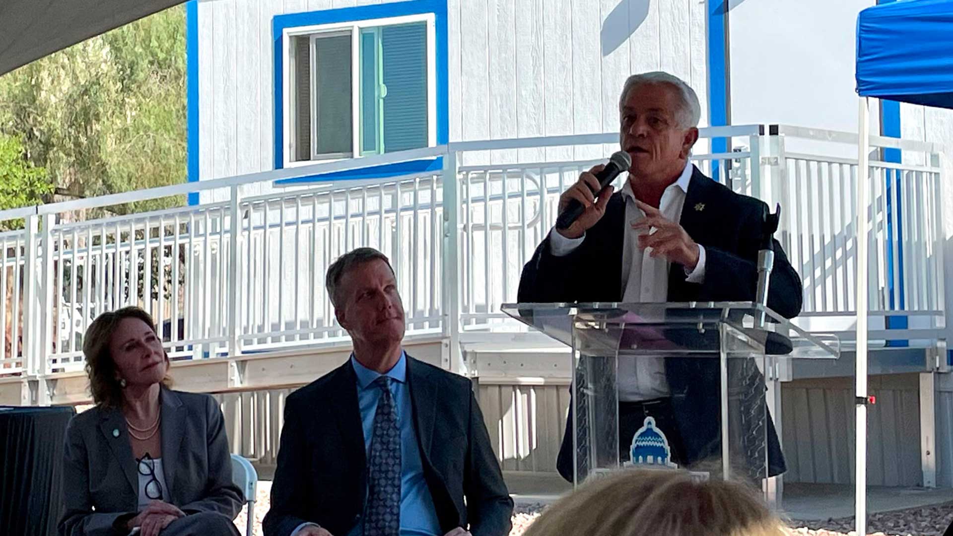 Pima County Sheriff Chris Nanos, accompanied by Pima County Administrator Jan Lesher and Pima County Supervisor Rex Scott, speaks at the grand opening of the Pima County Transition Center in Tucson, Ariz. on Thursday, Sept. 7, 2023. 