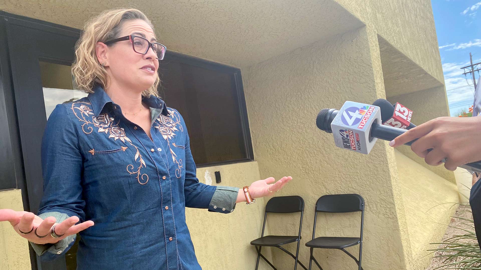 Sen. Kyrsten Sinema talks to reporters in Tucson on Sept. 8, 2023.