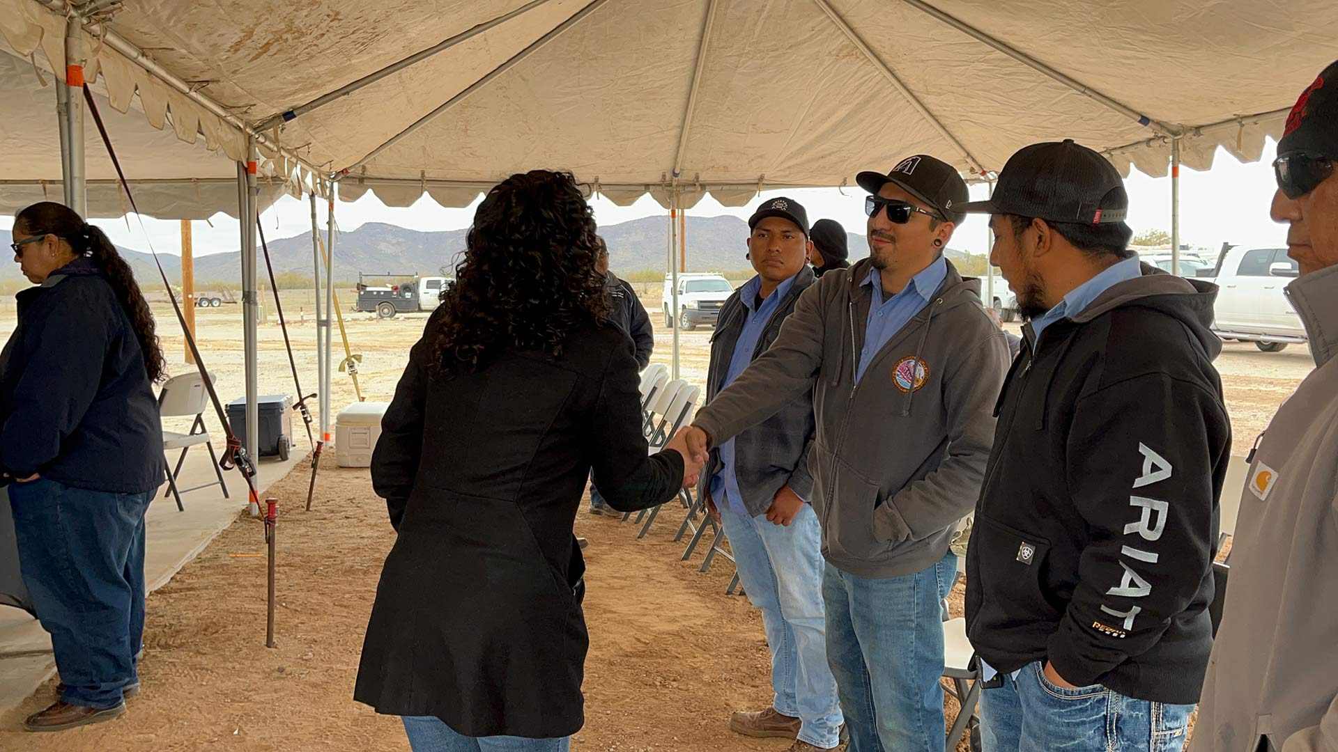 USDA Deputy Secretary Xochitl Torres Small shakes the hand of a Tohono O'odham Utility Authority employee during the groundbreaking near the Hickisaw District Office on Thursday, Jan. 11, 2023.