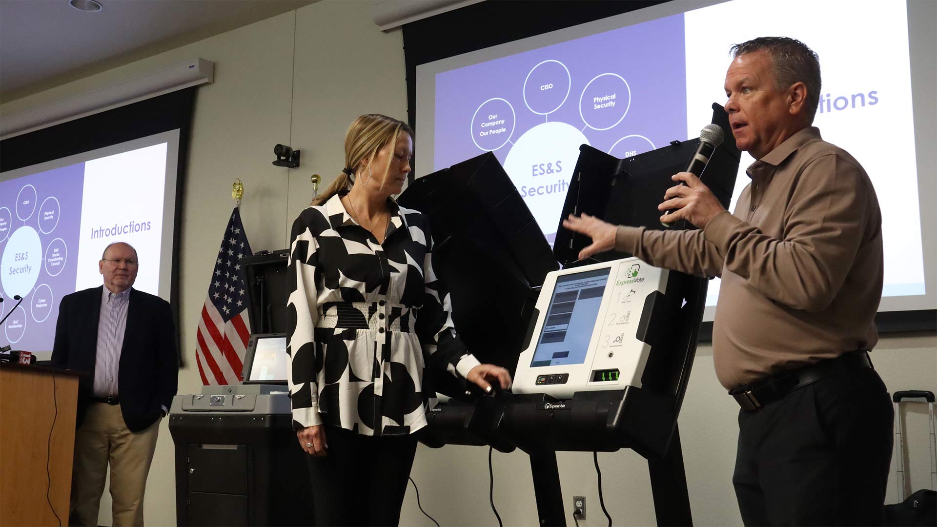 Election Systems & Software Vice President of Sales Bryan Hoffman (right) walks the audience through a demonstration of voting equipment with Arizona Senior Account Manager Susan Parmer (center) and Chief Information Security Officer Chris Wlaschin (left). January 17, 2023.