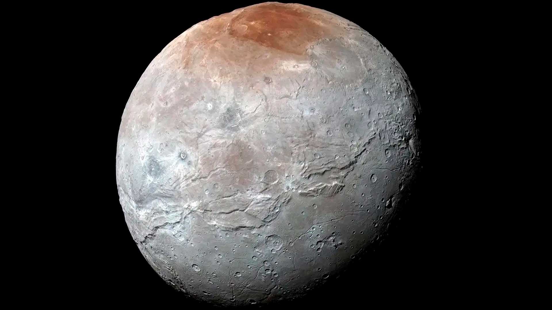 This image provided by NASA shows an enhanced color view of Pluto’s big moon Charon captured by the New Horizons spacecraft, July 14, 2015. 