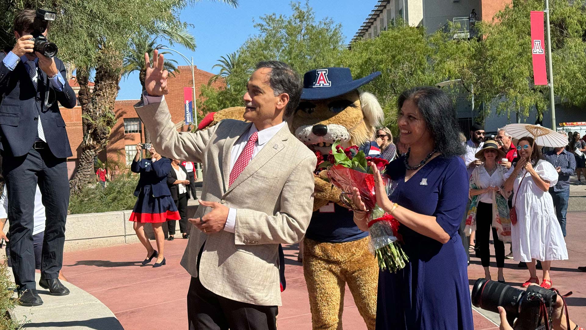 University of Arizona President Suresh Garimella makes the Wildcat sign alongside his wife Lakshmi Garimella during his first on-campus workday in Tucson, Ariz. on Wednesday, Oct. 2, 2024. 