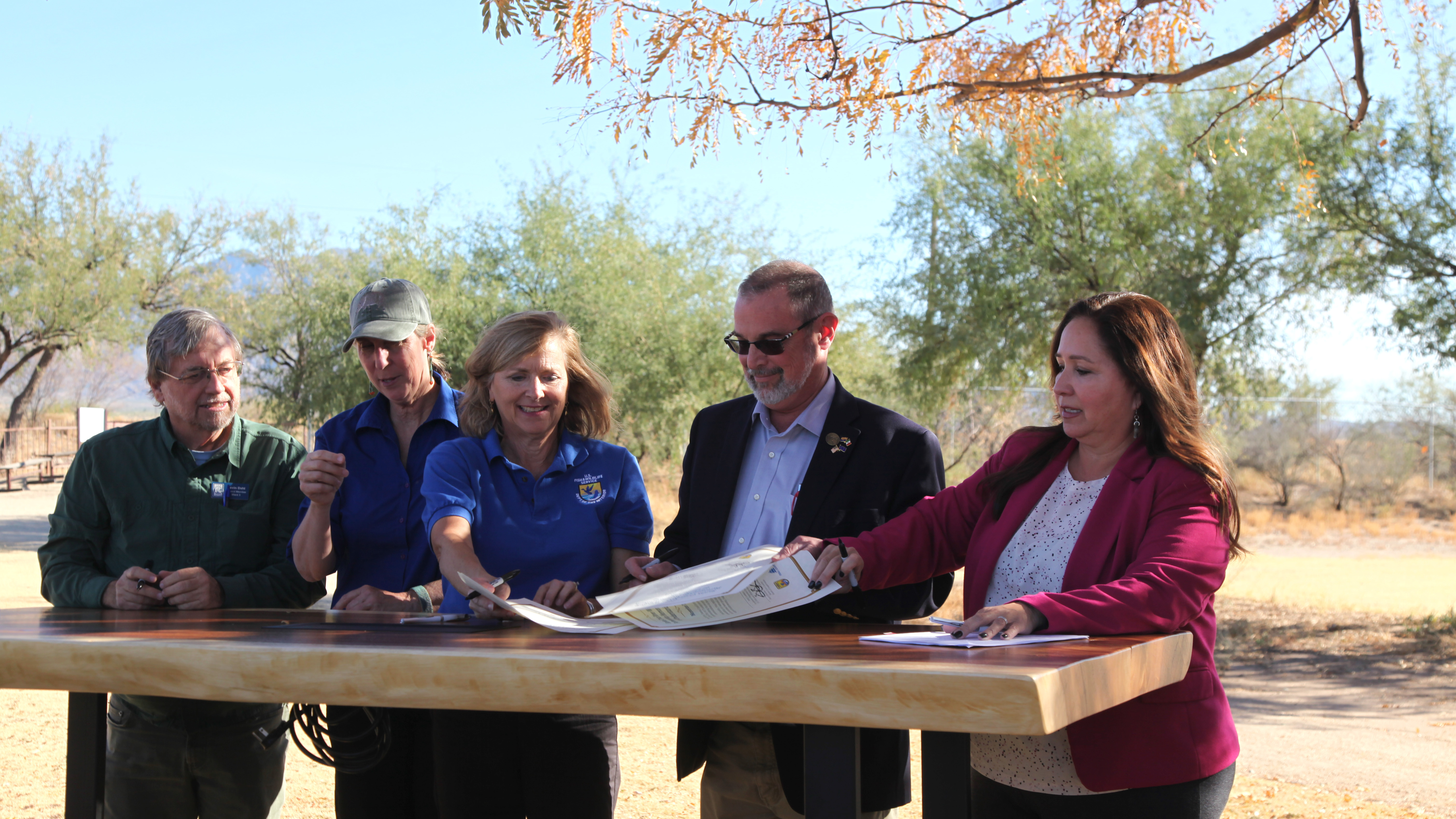 Officials from local and federal agencies sign the Santa Cruz River Wildlife Partnership Memo of Understanding at the Historic Canoa Ranch in Green Valley, Ariz., on Thursday, Nov. 21, 2024. From left to right: Kevin Dahl, City of Tucson council member for Ward 3, Martha Williams, Director for the U.S. Fish and Wildlife Service, Amy Lueders, Southwest Regional Director for the USFWS, Bruce Bracker, Santa Cruz County Vice-Chair and Supervisor for District 3 and Adelita Grijalva, Pima County Chair and Supervisor for District 5. 