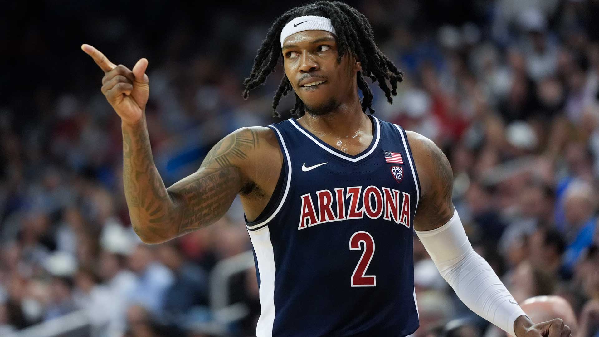Arizona guard Caleb Love (2) points to a teammate during the first half of an NCAA college basketball game against UCLA in Los Angeles, Thursday, March 7, 2024. 