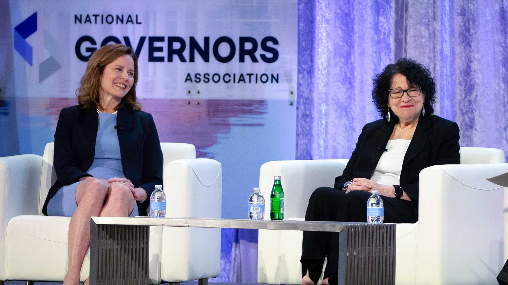 Supreme Court Justices Amy Coney Barrett, left, and Sonia Sotomayor speak with retired U.S. Appeals Court Judge Thomas Griffith, not shown, during a panel discussion at the winter meeting of the National Governors Association, Feb. 23, 2024 in Washington. In joint appearances less than three weeks apart, ideologically opposite Justices Amy Coney Barrett and Sonia Sotomayor said a Supreme Court where voices don’t get raised in anger can be a model for the rest of the country in these polarized times. 