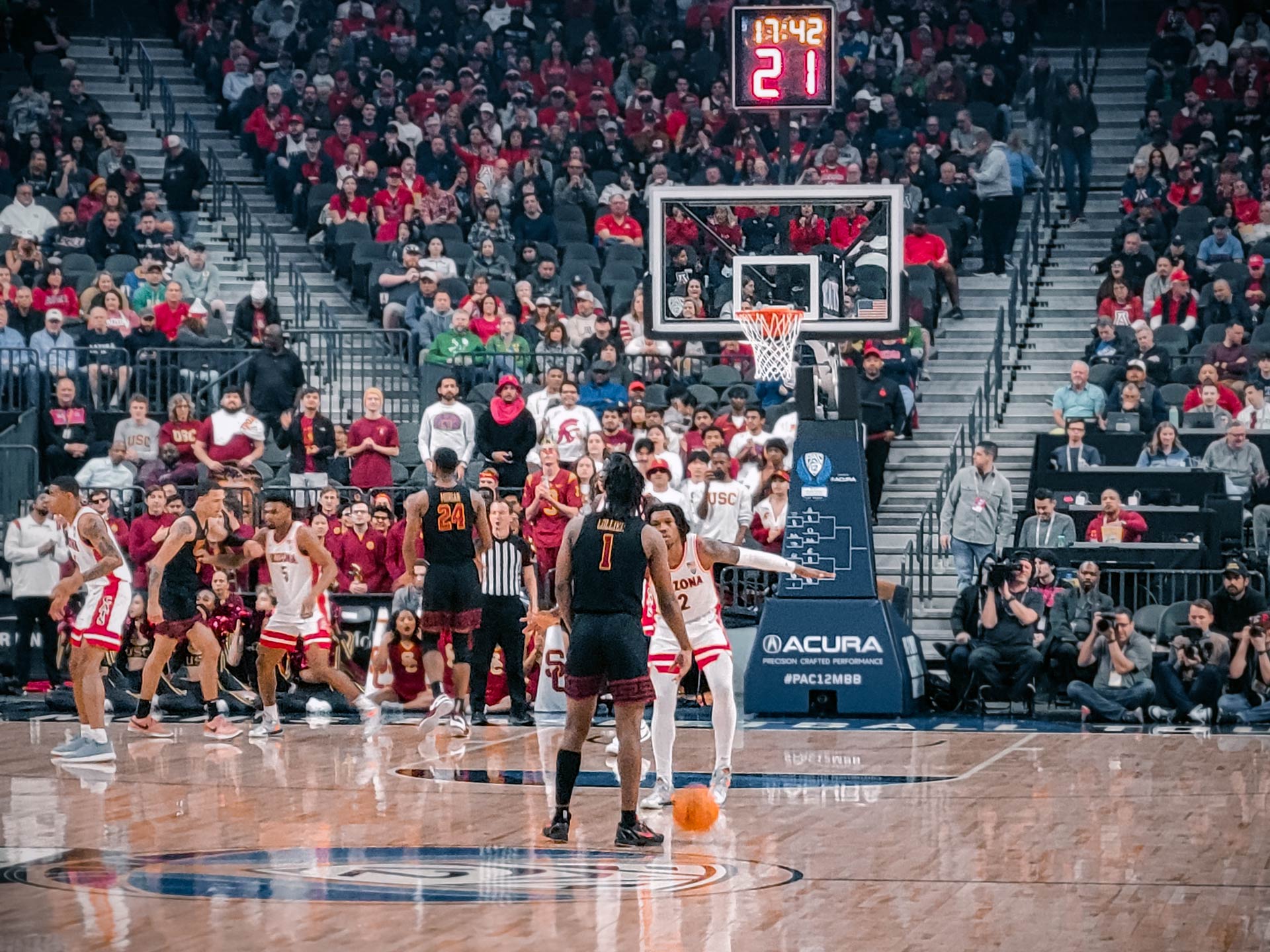 University of Arizona Wildcat guard, Caleb Love, defends against USC's Isaiah Collier in their first game in the 2024 Pac-12 Men's Basketball Tournament.