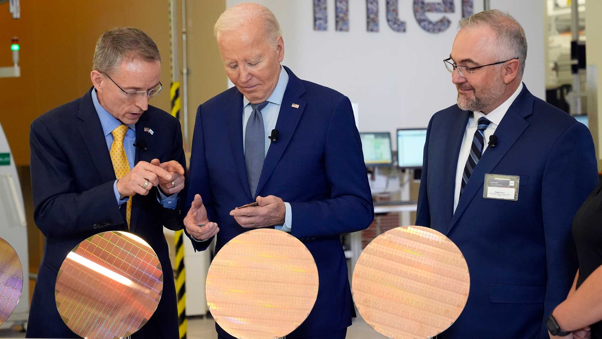 President Joe Biden listens to Intel CEO Pat Gelsinger, left, as Intel factory manager Hugh Green listens, during a tour of the Intel Ocotillo Campus, in Chandler, Ariz., Wednesday, March 20, 2024. 
