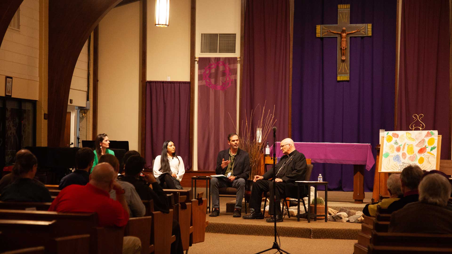 Gabrielle Cardenas, Brian Eller, and Bishop Edward Weisenburger sit on a panel discussion moderated by Ellen Fisher, on Monday, March 18, at the St. Thomas More Newman Center in Tucson, Ariz. Fisher (left) is the assistant director of the Catholic University of America in Tucson.