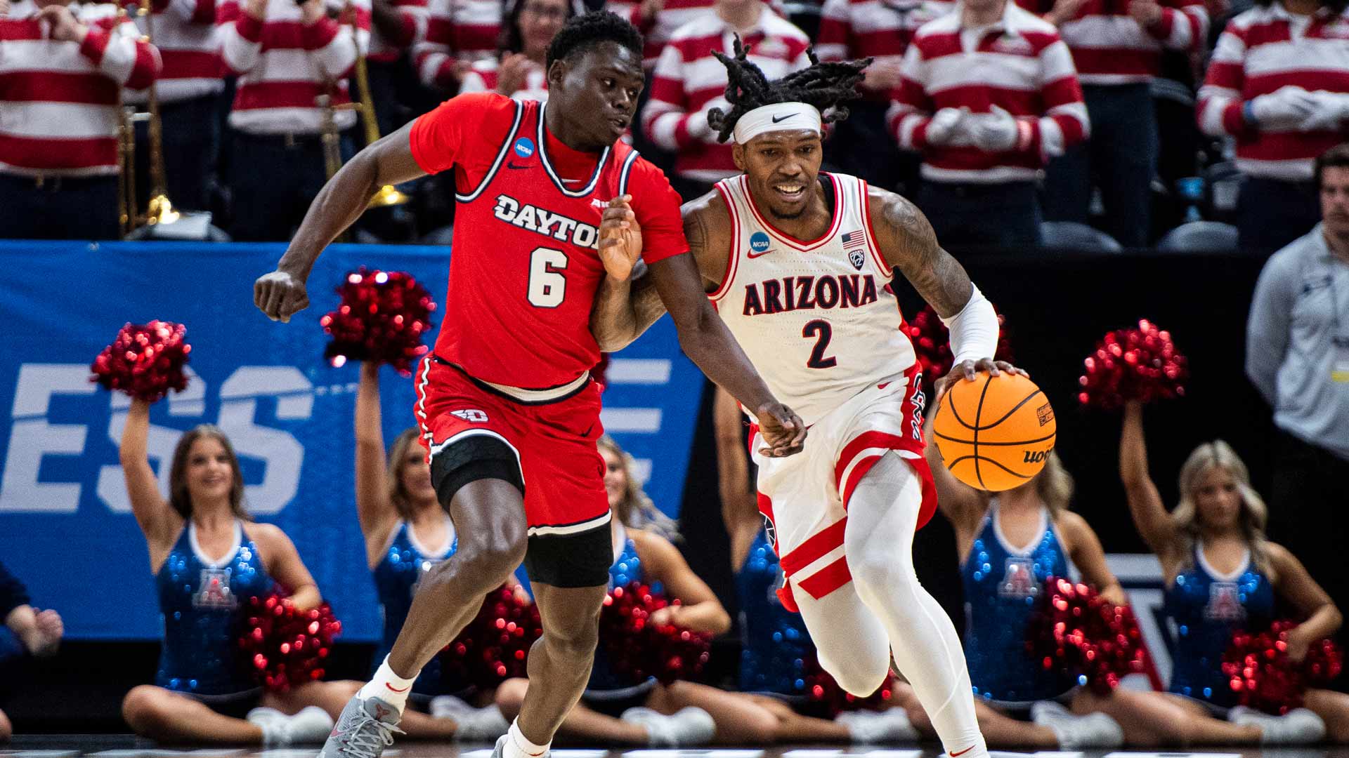 Arizona guard Caleb Love (2) brings the ball up court while guarded by Dayton guard Enoch Cheeks (6) during the first half of a second-round college basketball game in the NCAA Tournament in Salt Lake City, Saturday, March 23, 2024. 