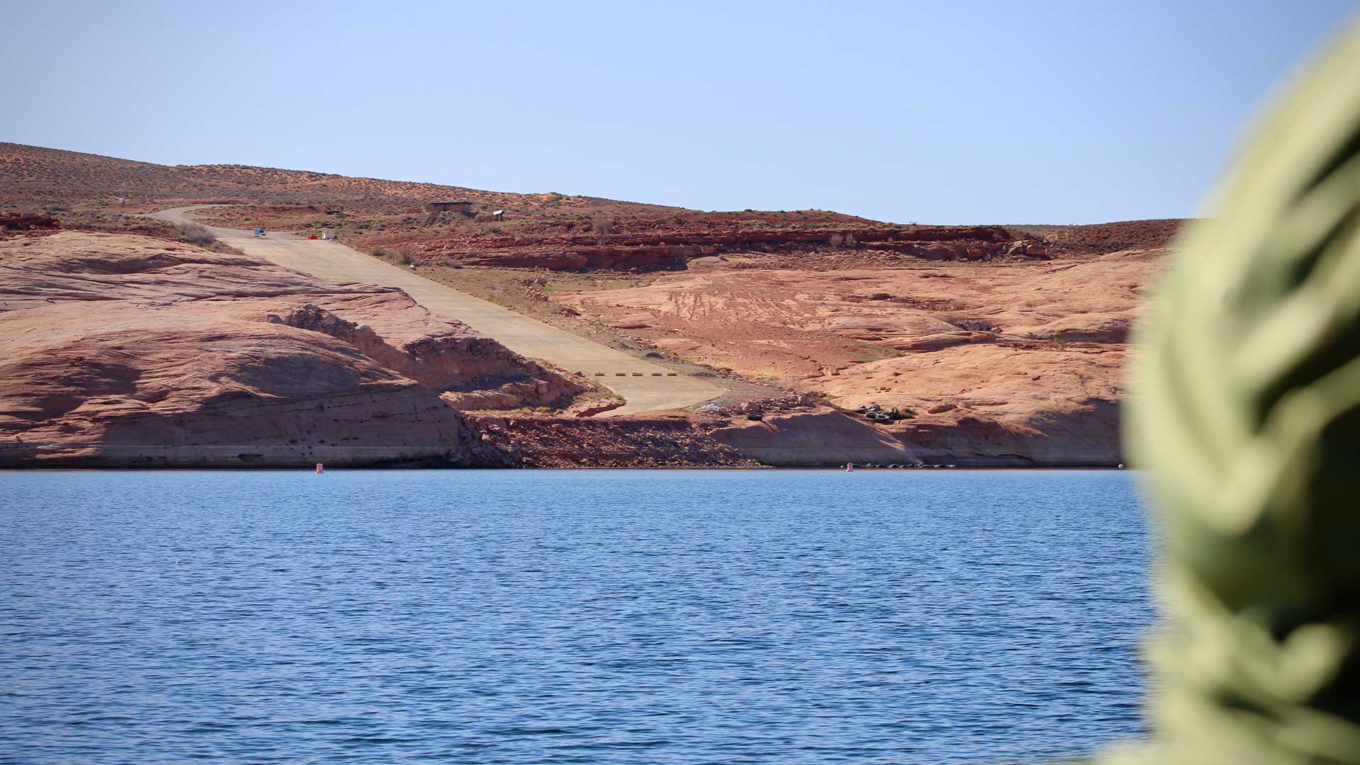 A boat ramp, once partially submerged under Lake Powell, sticks out of the water on April 10, 2023. The nation's second-largest reservoir, which is filled by the Colorado River, has reached record low levels in recent years. Policymakers are stuck in a standoff about how to reduce demand on the reservoir and river.
