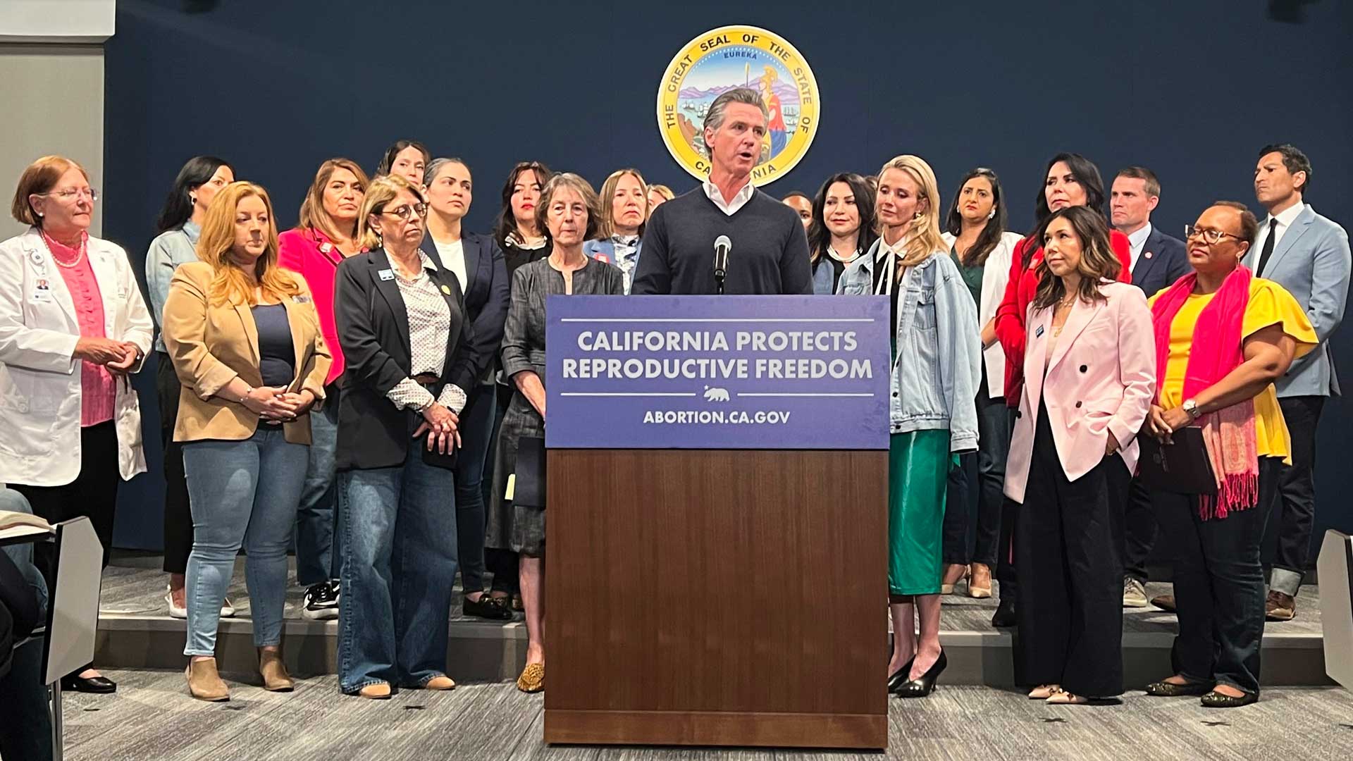 Joined by the state Legislative Women's Caucus and advocates, California Gov. Gavin Newsom, center, speaks during a news conference, Wednesday, April 24, 2024, in Sacramento, Calif., to announce legislation that would help Arizona women access abortions. The proposal would circumvent a ban on nearly all abortions in Arizona by allowing Arizona doctors to give their patients abortions in California. 
