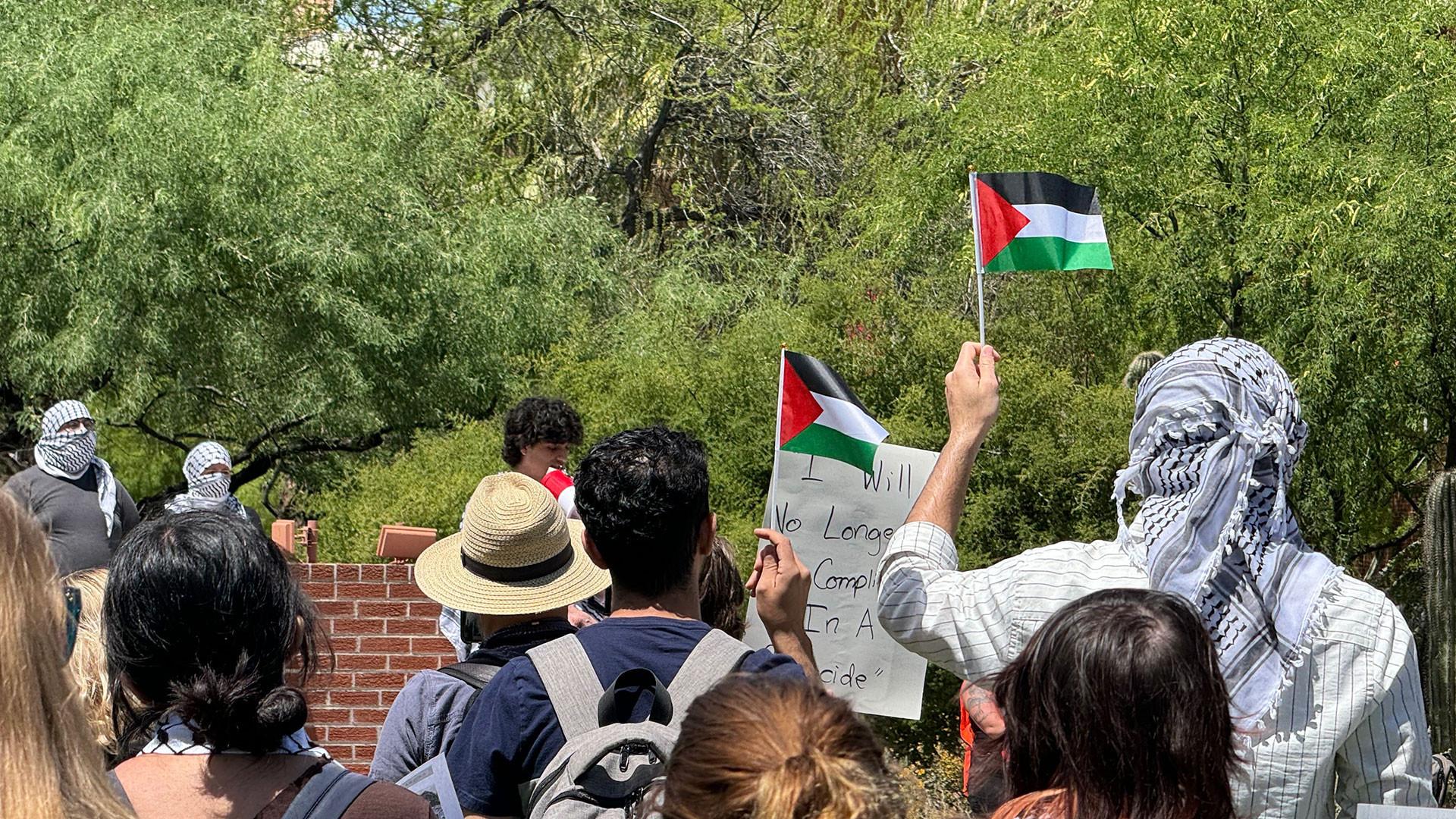 Two protestors hold Palestinian flags at a rally on the University of Arizona Campus on Thursday, April 25, 2024. 