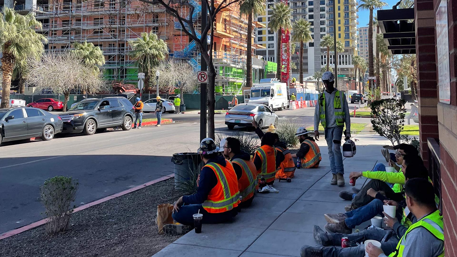 Construction workers take a lunch break in downtown Phoenix. The city has gained almost 200,000 new residents since 2020, according to the Census Bureau, fueling a construction boom. 