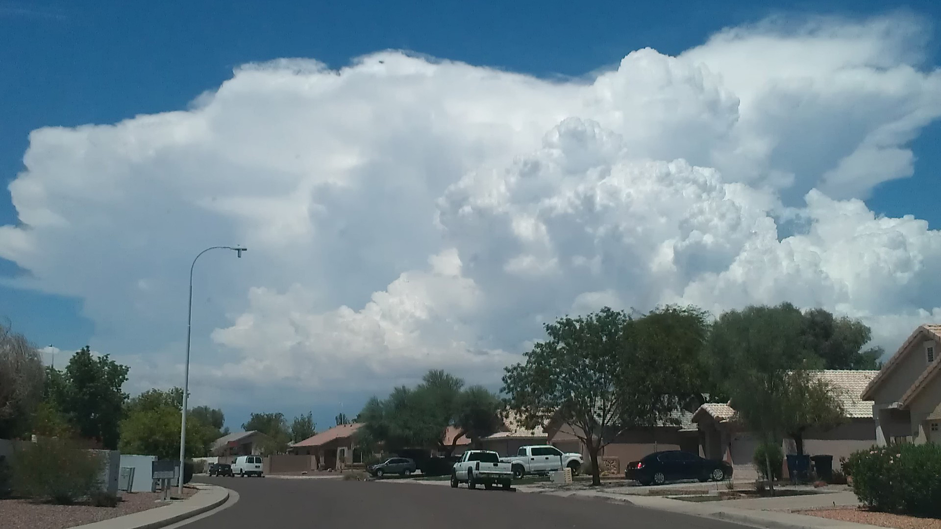 Monsoon clouds hover above a southern Arizona neighborhood.