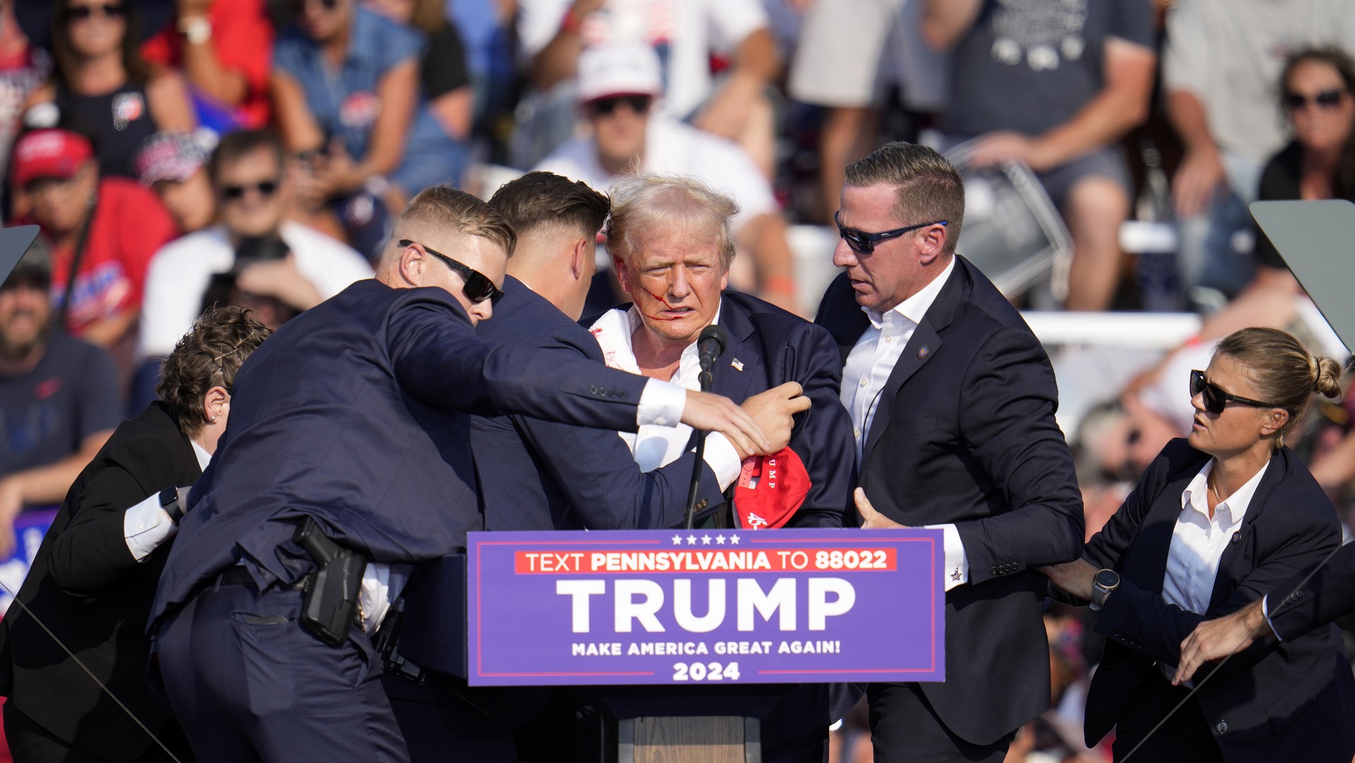 Republican presidential candidate former President Donald Trump is helped off the stage at a campaign event in Butler, Pa., on Saturday, July 13, 2024.