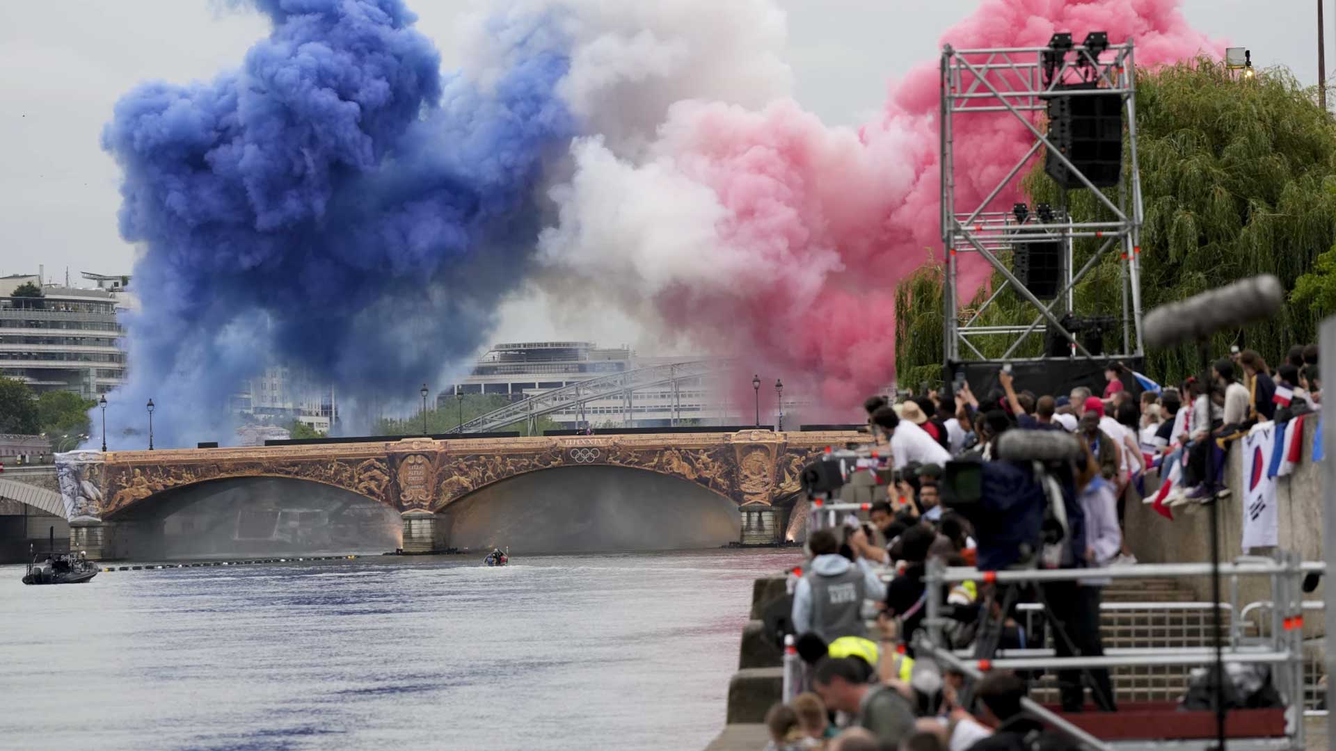 Smoke in the colors of the French flag billows in Paris to start the opening ceremony.