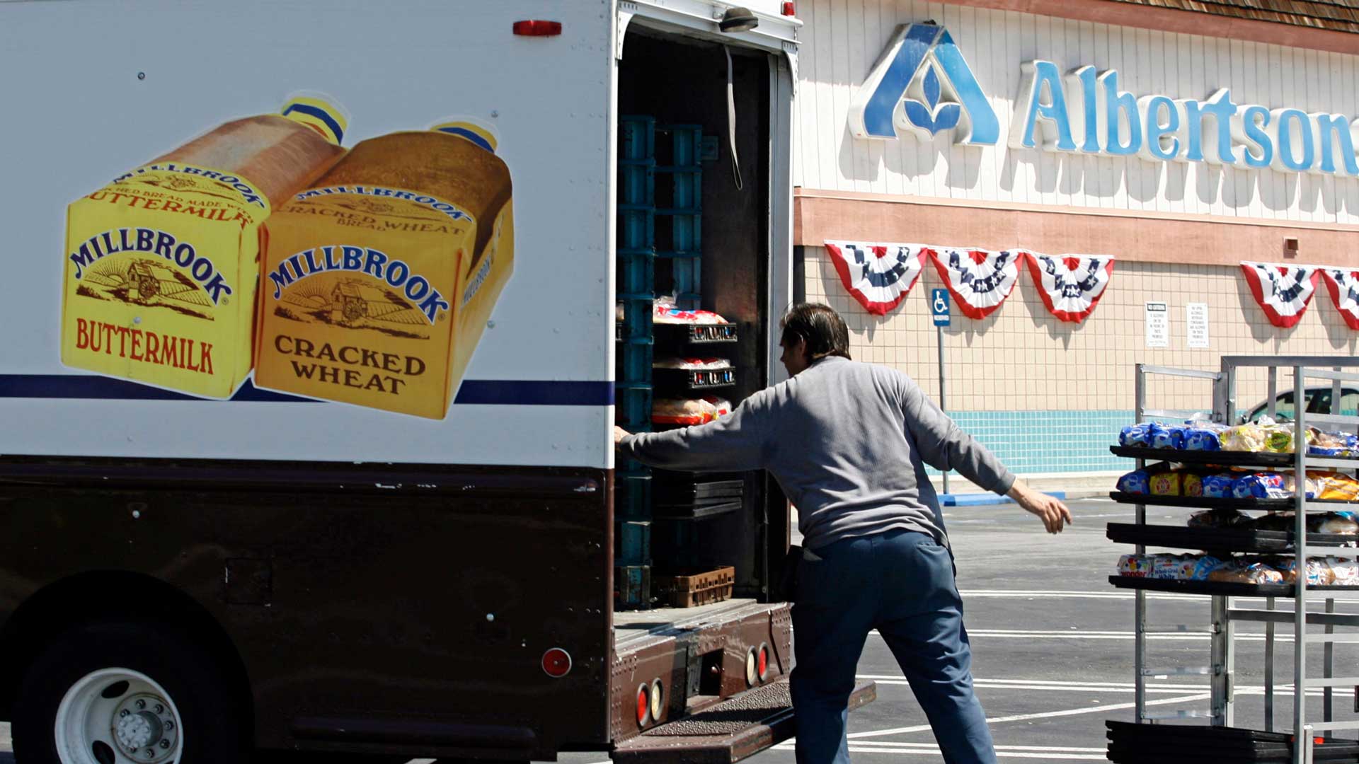 FILE - Mitch Maddox, a bread route salesman, loads bread outside the Eagle Rock Albertsons store in Los Angeles, May 30, 2006. (AP Photo/Damian Dovarganes, File)