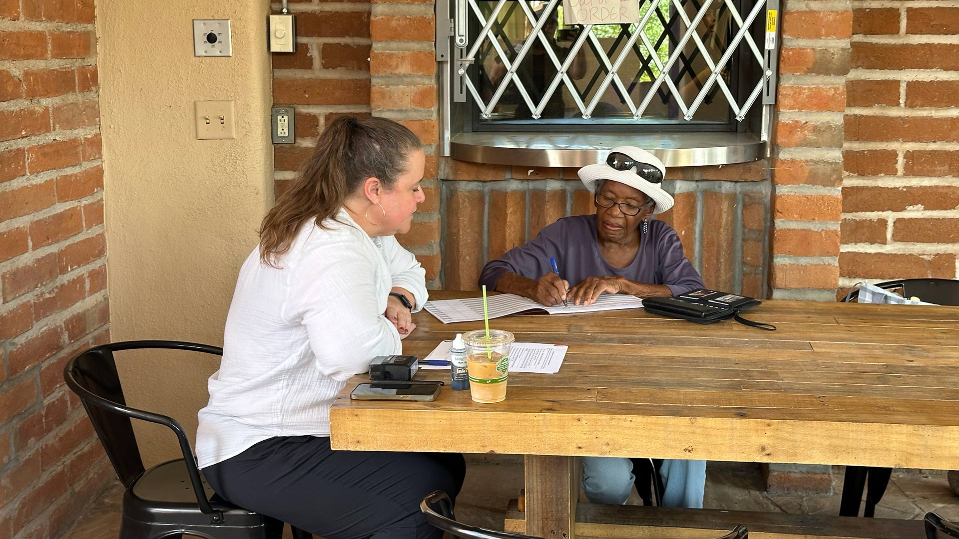 Vista Del Monte Neighborhood Association vice president Emily Ricketts signs a notarized amendment that would remove racist covenants from three out of the eight developments in her neighborhood.