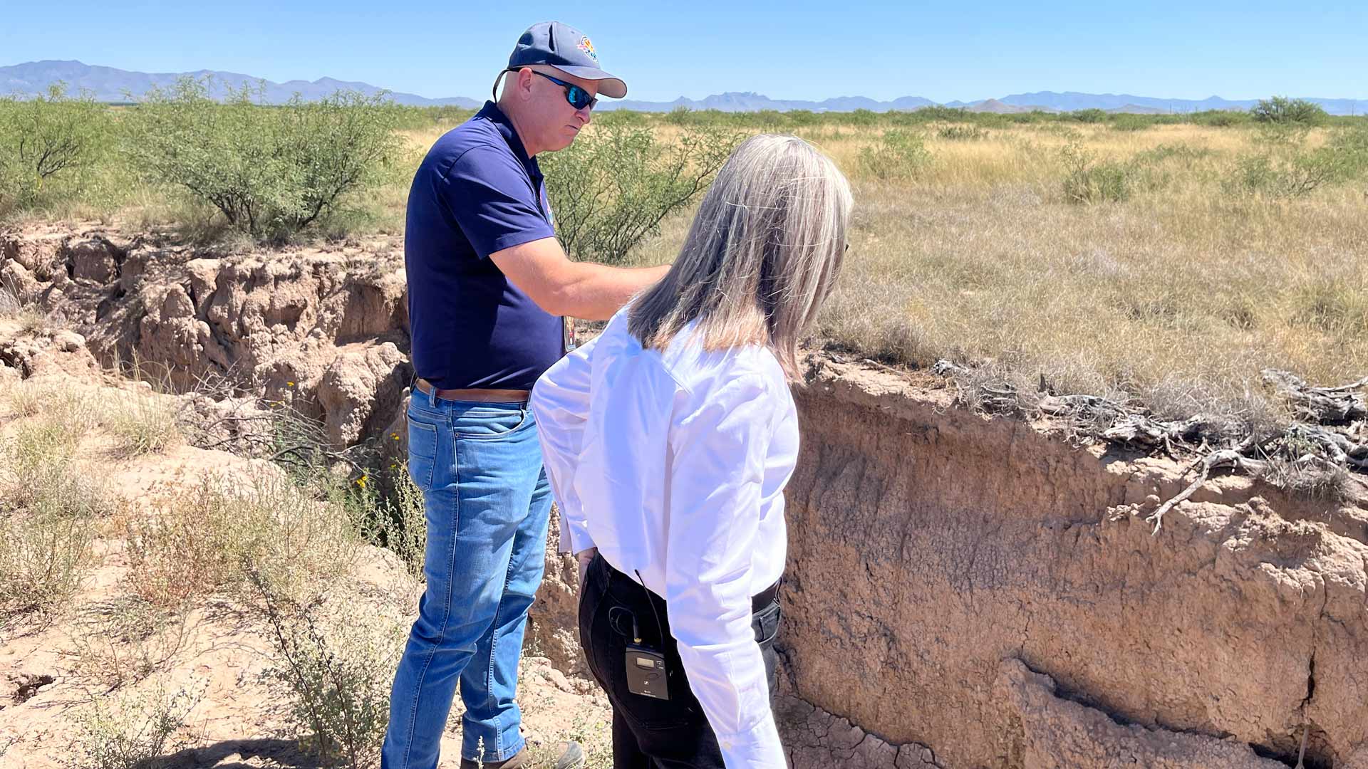 Governor Katie Hobbs and an ADWR staff member look at a fissure near Willcox, AZ.  The fissure is caused by dropping water levels in the aquifer. September 5, 2024