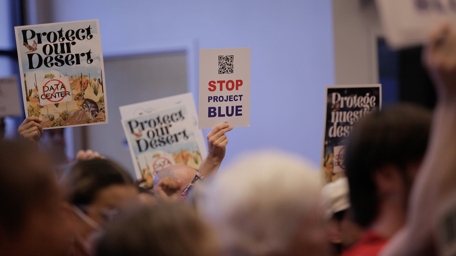Protesters hold up signs against the Project Blue datacenter at a Pima County Board of Supervisors meeting on Oct. 21. The $3 billion project is set for a 290-acre parcel of land down Houghton Road.