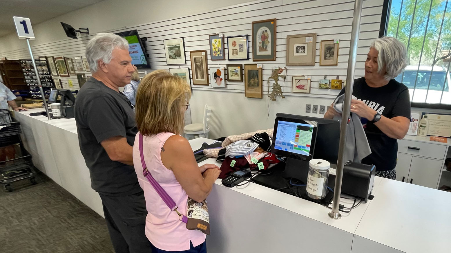 Monique Van Sickle, a volunteer marketing and communications board member, tends to one of the registers at the group's thrift store.  On Thursday May 1, 2025 the organization will change its name from the Assistance League of Tucson to Viva Pima! 

