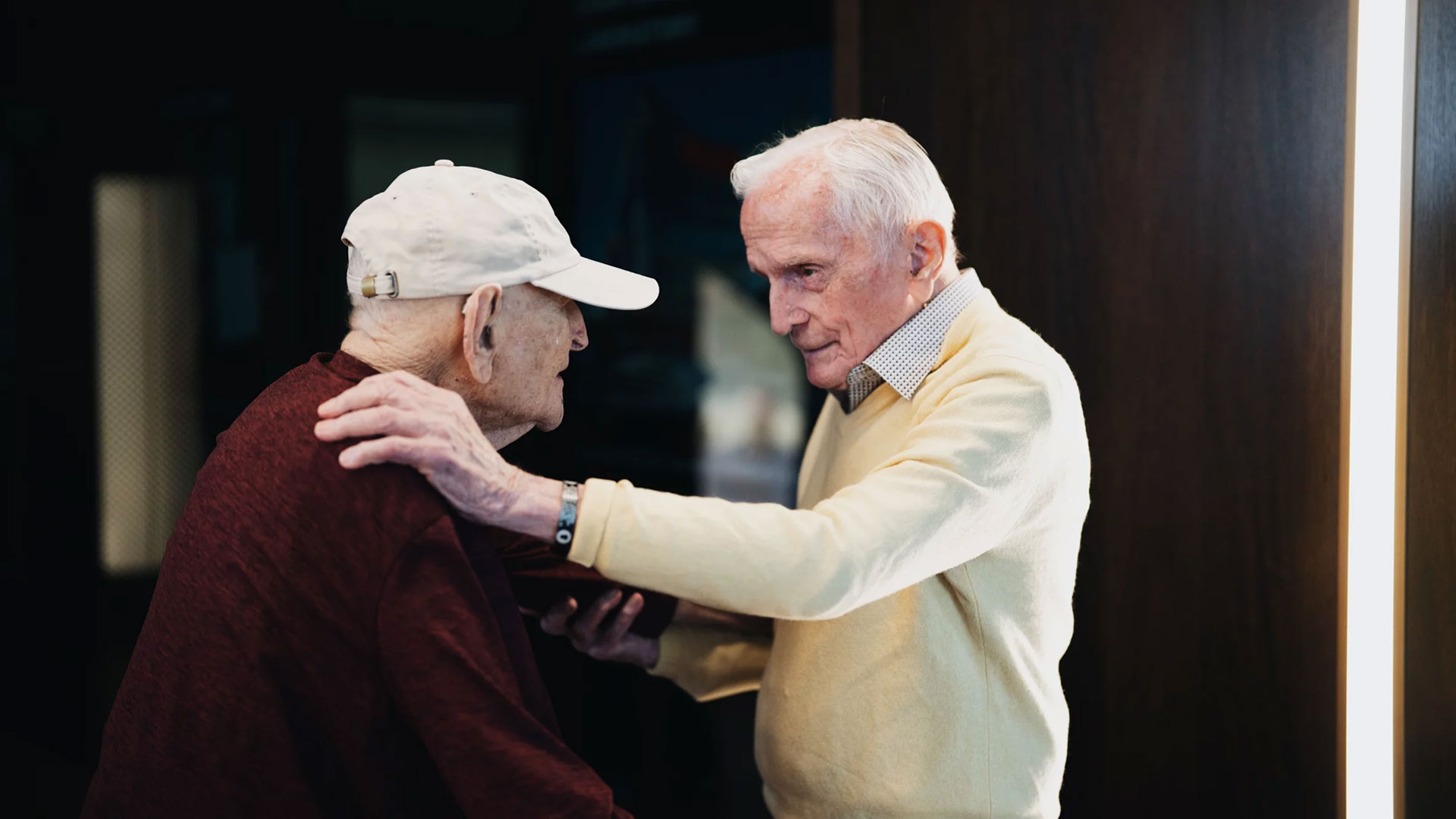 Andrew Roth (left) stands up from his wheelchair to give Jack Moran a hug at the Shoah Foundation at the University of Southern California in Los Angeles. Roth was imprisoned in the Buchenwald concentration camp, which Moran helped liberate while serving in the U.S. Army.