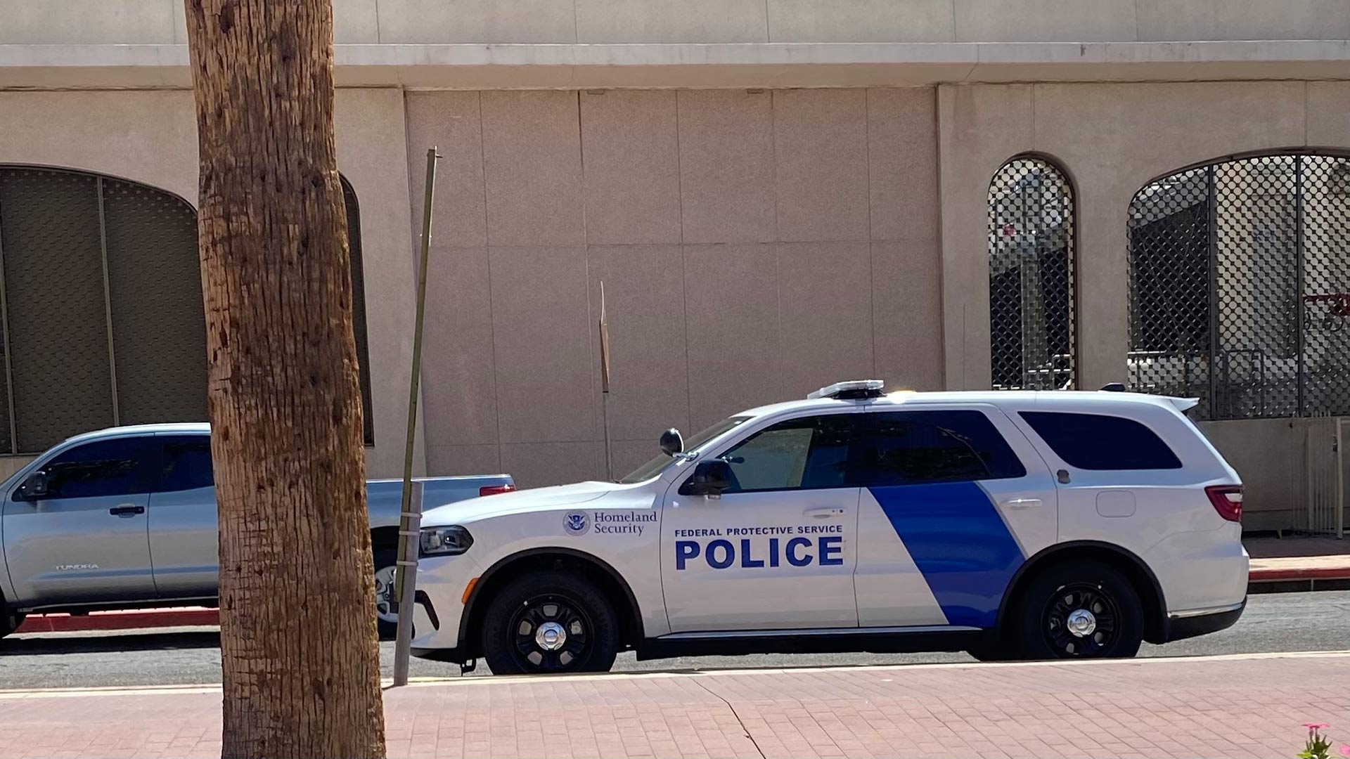 Two Department of Homeland Security vehicles are parked outside Tucson Immigration Court on June 3, 2025.