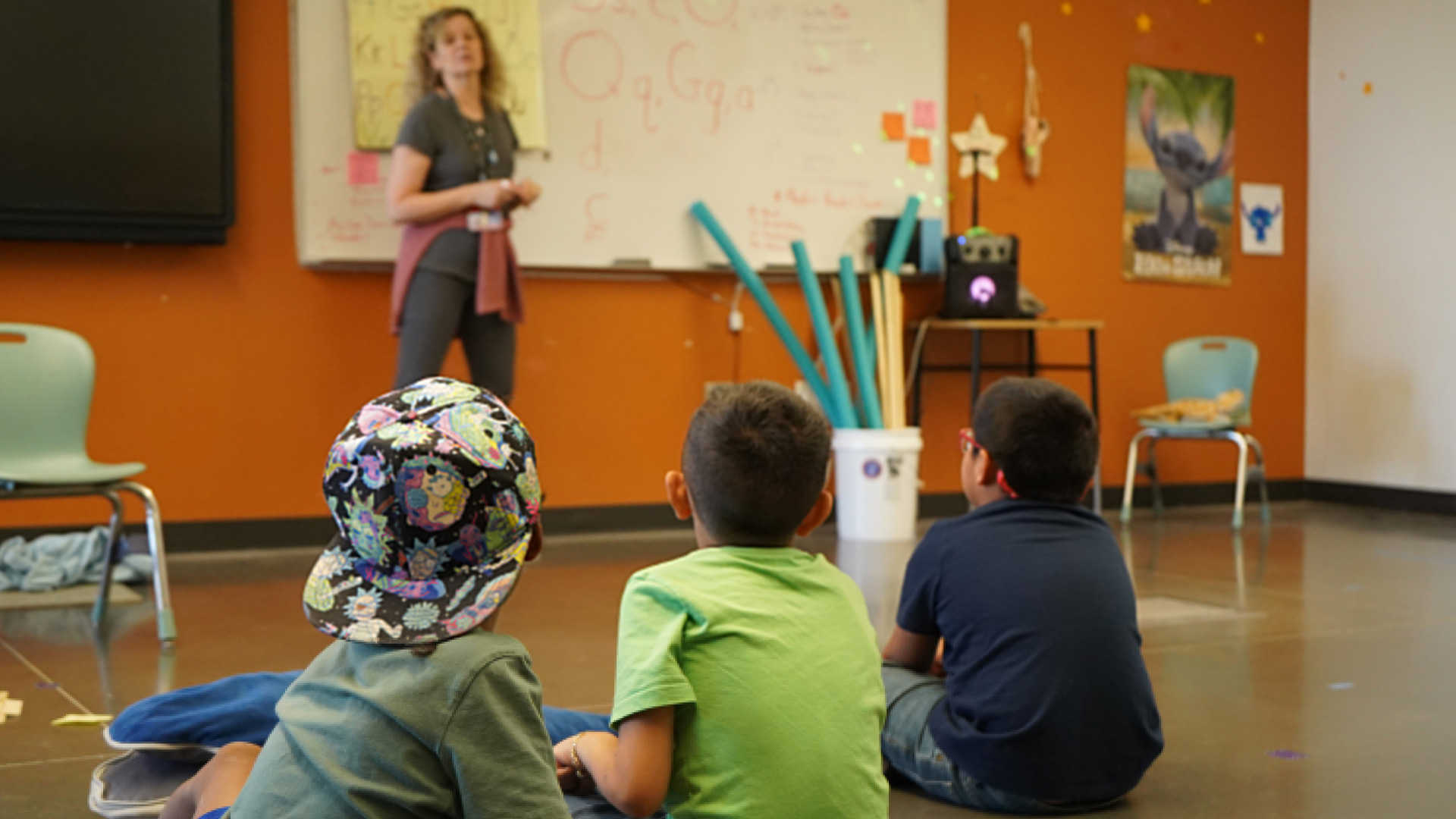 Three kindergarden boys listen to Amy Stallman, the OMA teacher, during TUSD summer school program at the Mary Belle McCorkle Academy of Excellence.