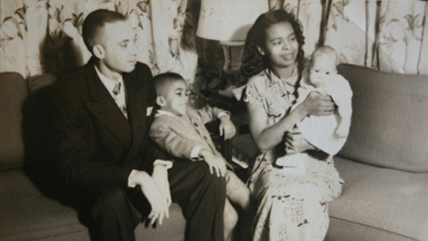 Tom Joyner as an infant pictured with his parents and brother.
