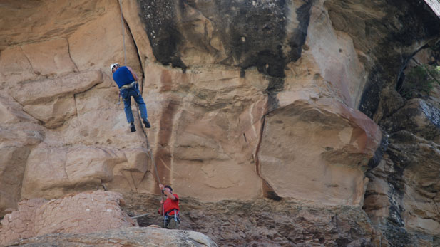 TIME TEAM AMERICA digging team member descends into a cliff-side granary left intact by the Fremont Indians 1,000 years ag